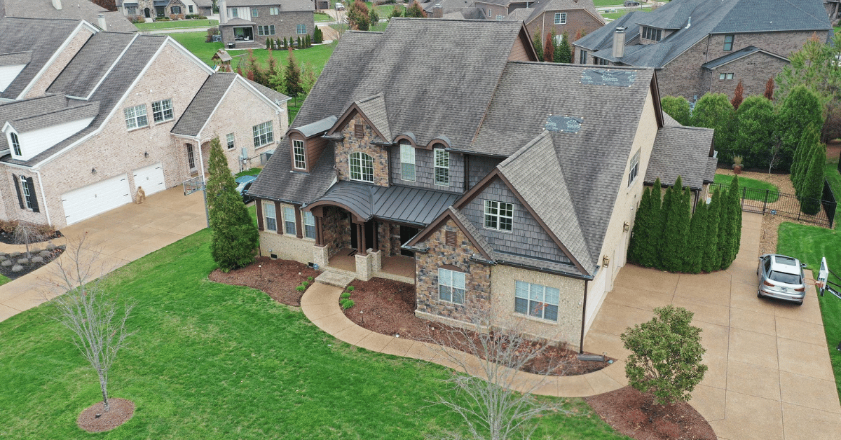 Aerial View of Brentwood Home Before Roof Replacement Overhead photo of a 5,184 sq ft home in Brentwood, TN, prior to roof replacement by Five Points Roofing.
