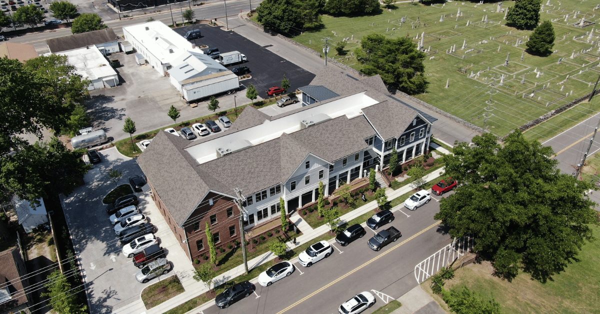 Completed Roof Installation on 4th Ave Shell Office Building Aerial view of the finished roof featuring asphalt shingles and standing seam metal in downtown Franklin.