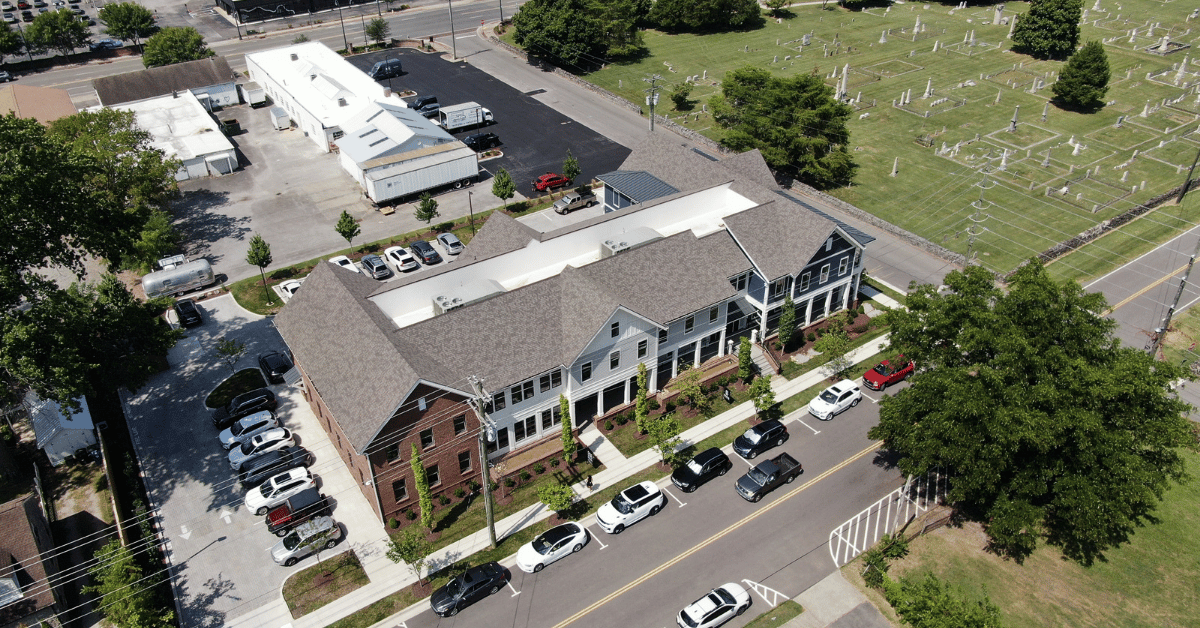 Aerial view of the finished roof featuring asphalt shingles and standing seam metal in downtown Franklin.