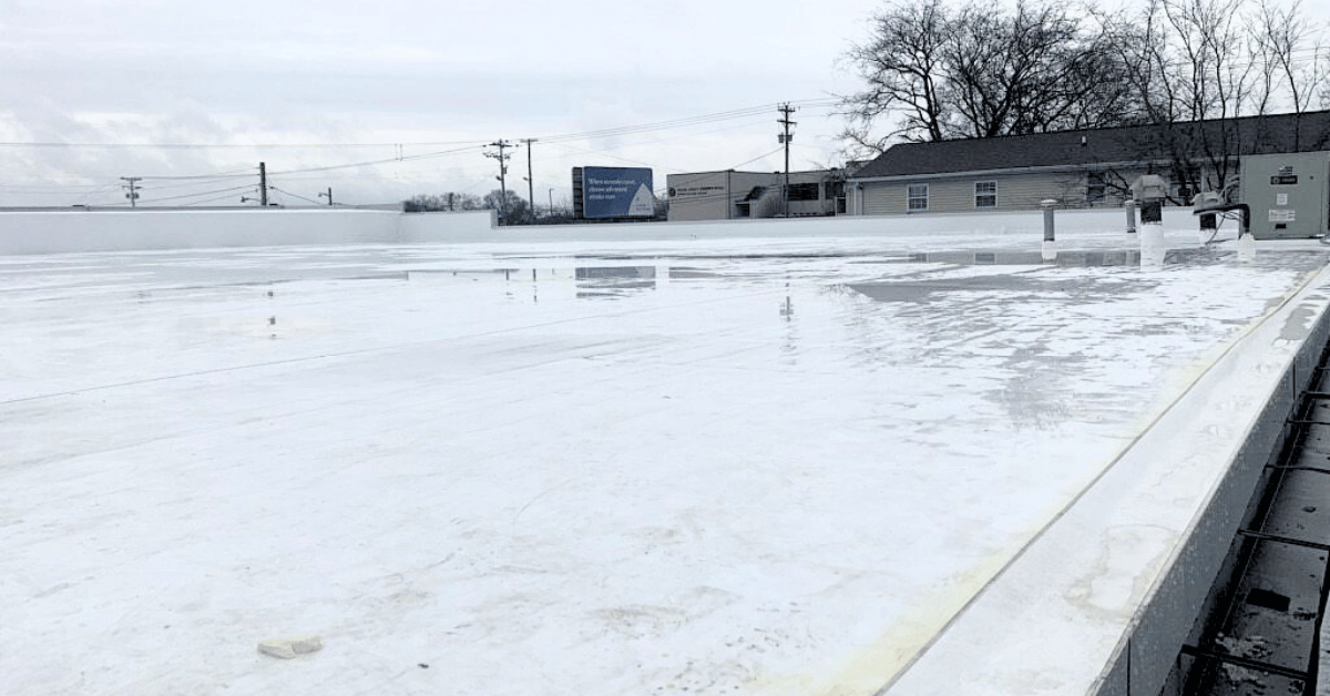 Completed White TPO Flat Roof System Finished flat roof with reflective white TPO membrane installed over the concrete deck for improved waterproofing and energy efficiency.