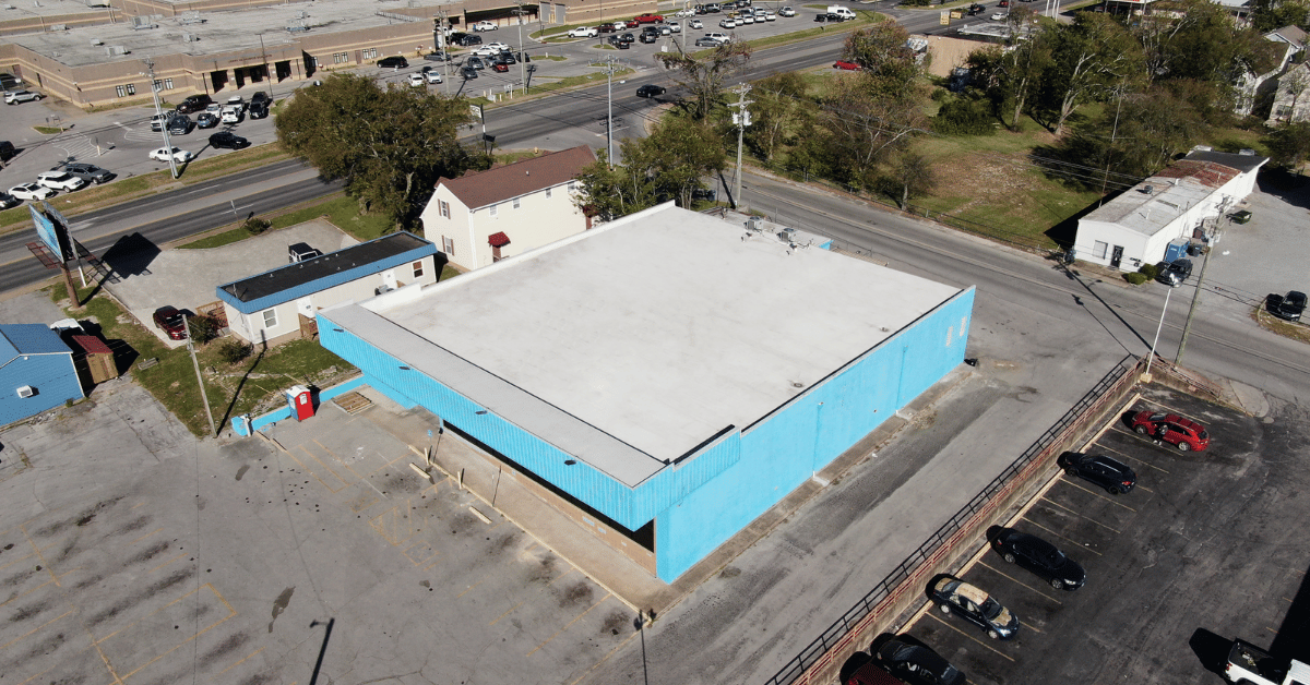 Side aerial perspective of the Lebanon Thrift Building, highlighting the smooth, waterproof TPO roofing system installed by Five Points Roofing.