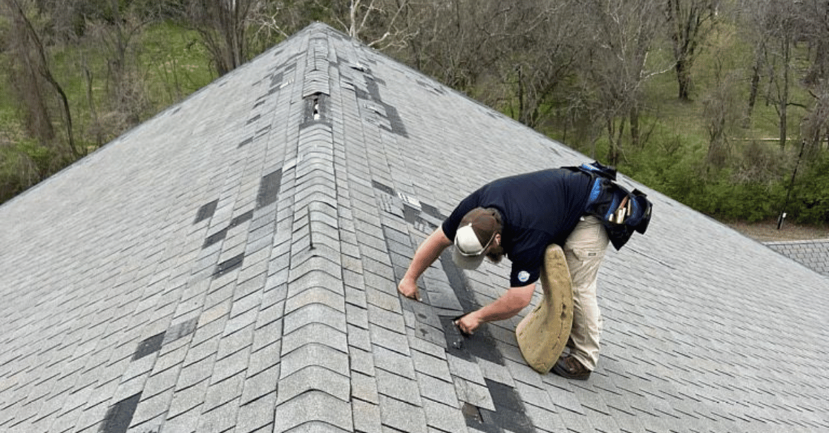 Technician Inspecting Storm-Damaged Roof Ridge