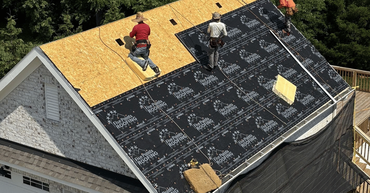 Roofing crew from Five Points Roofing installing new decking and branded waterproof underlayment on a residential home in Franklin, TN, as part of a full roof replacement.
