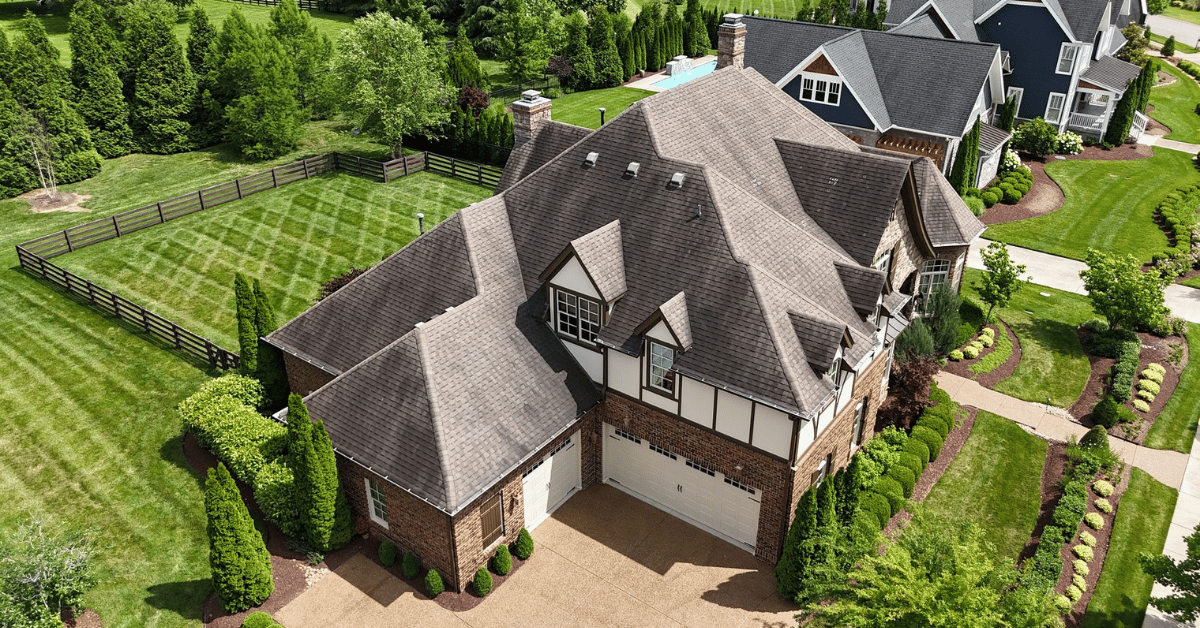 Top-down aerial photo showing finished roof installation, clean edge work, and updated roofing system.