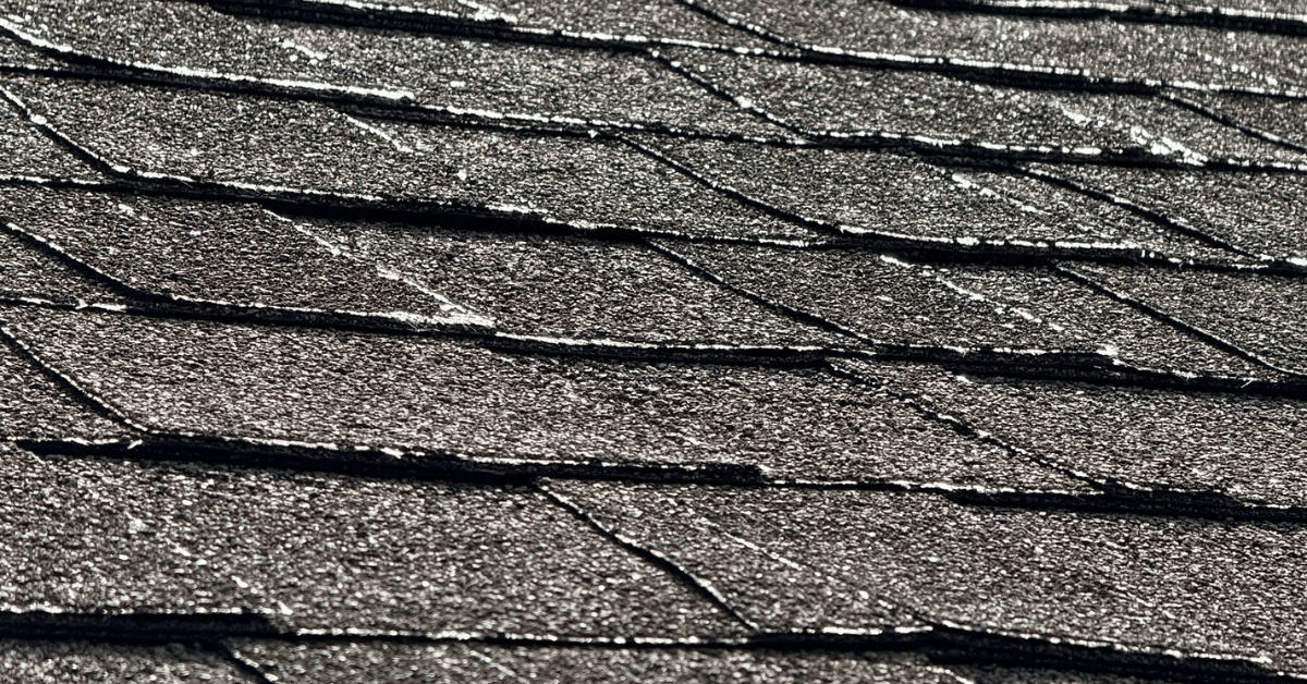Detailed view of asphalt shingles with curling and cracks caused by extreme heat and prolonged sun exposure in Middle Tennessee.