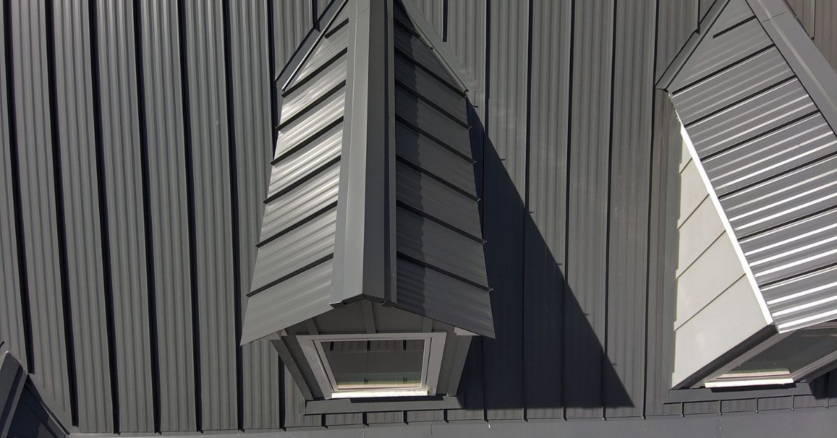 Detailed view of standing seam metal roof dormers, showcasing tight seam work, precision panel alignment, and modern architectural design.