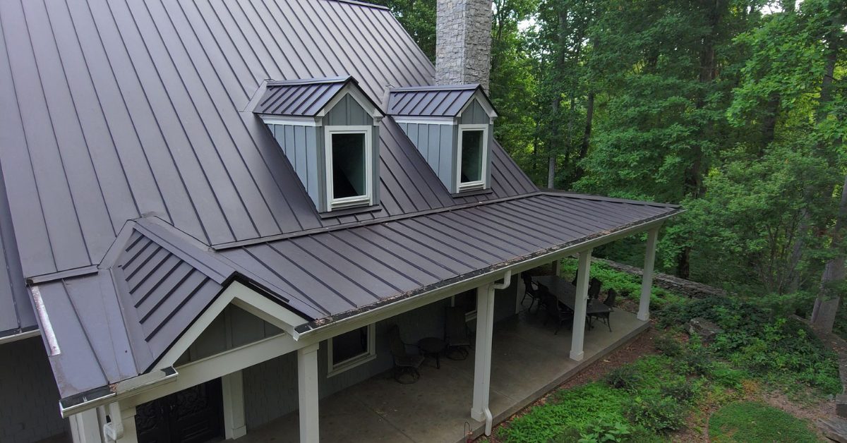 Close-up of a standing seam metal roof with visible wear and hail damage on a Franklin, TN home, taken before roof replacement by Five Points Roofing.