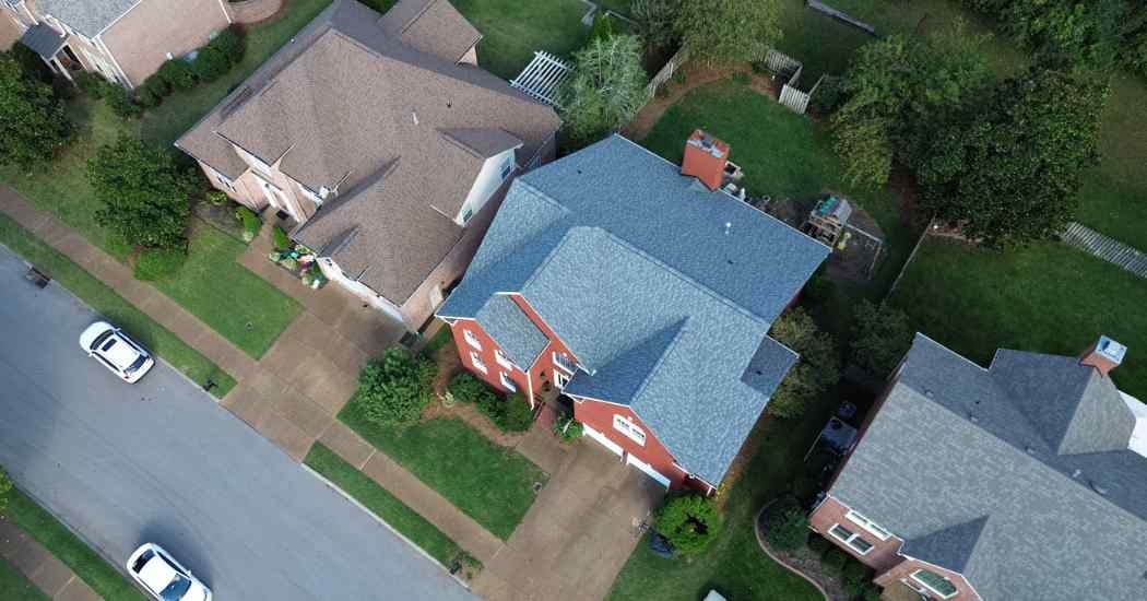 Drone photo of a Franklin, Tennessee home after a Five Points Roofing roof replacement, showing new architectural shingles and clean roof lines.
