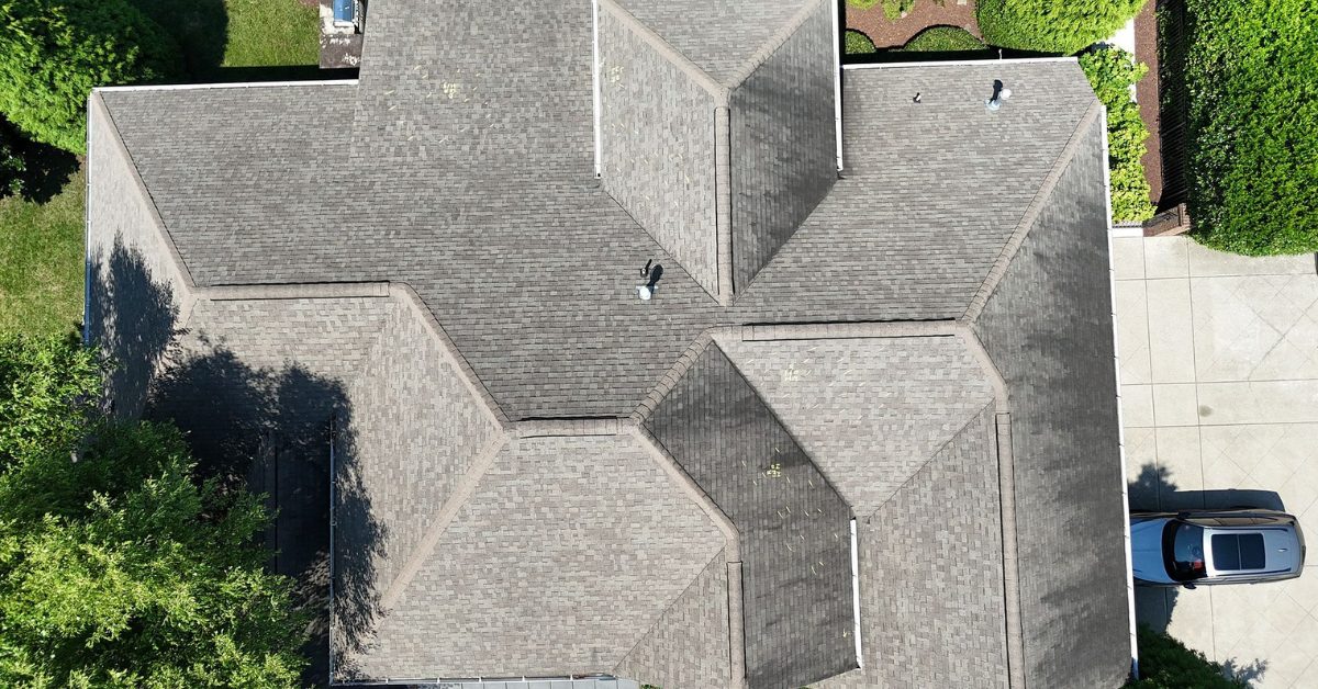 Aerial drone view of a completed asphalt shingle roof replacement on a large home in Franklin, Tennessee